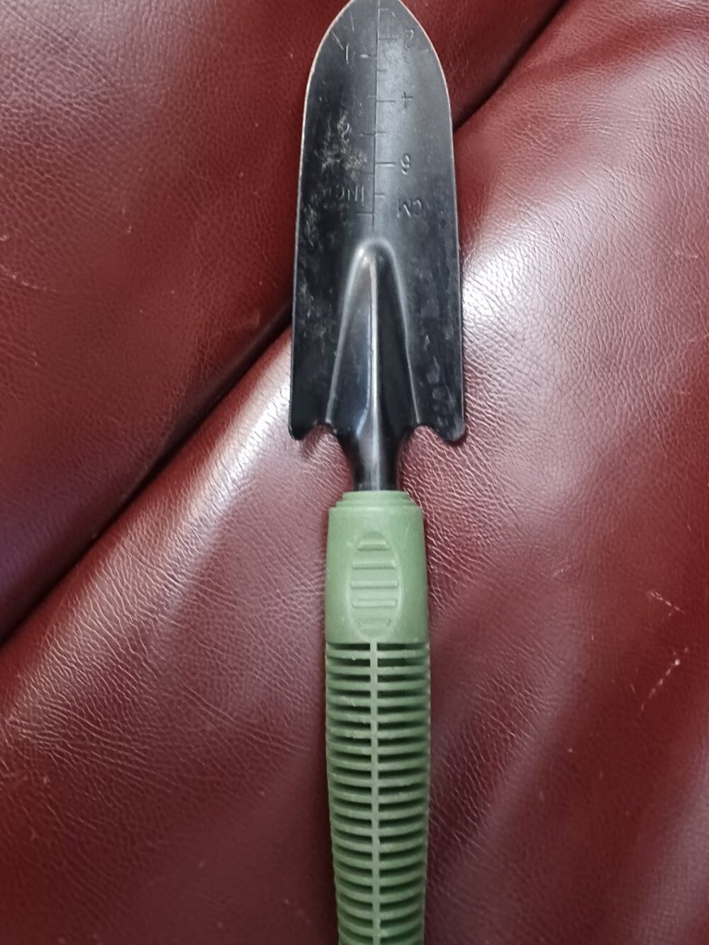 a garden hand tool specifically designed for shoveling tasks in the yard or gard